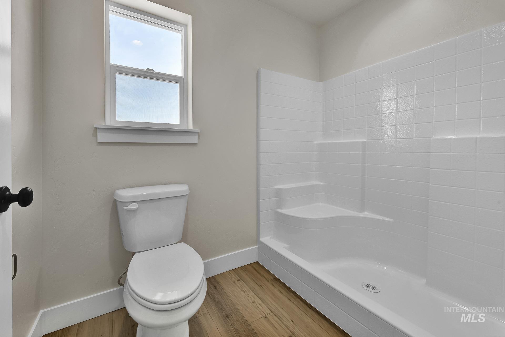 Bathroom with wood finished floors and a shower