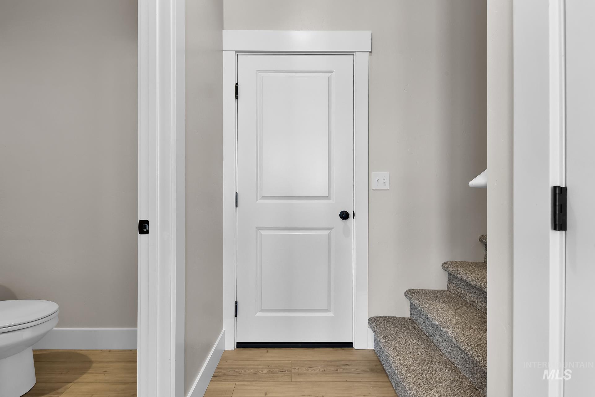 Staircase featuring wood finished floors and baseboards