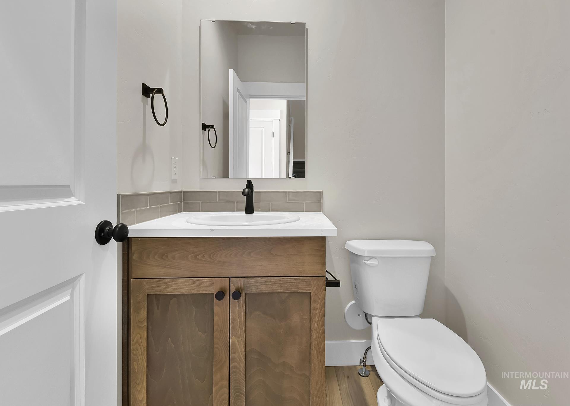 Half bathroom with vanity and toilet