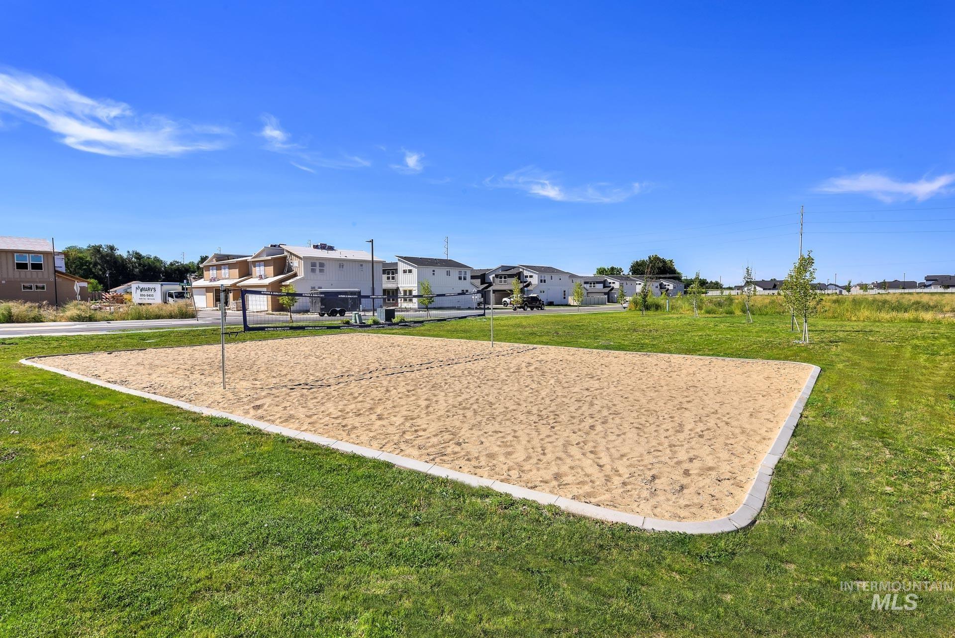 View of home's community with volleyball court, a yard, and a residential view