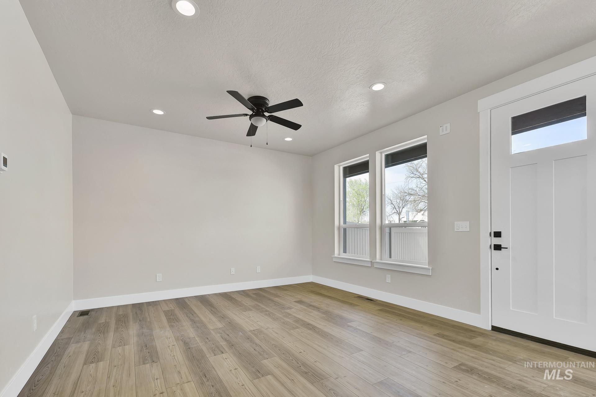 Entryway featuring recessed lighting, light wood-style floors, ceiling fan, and a textured ceiling