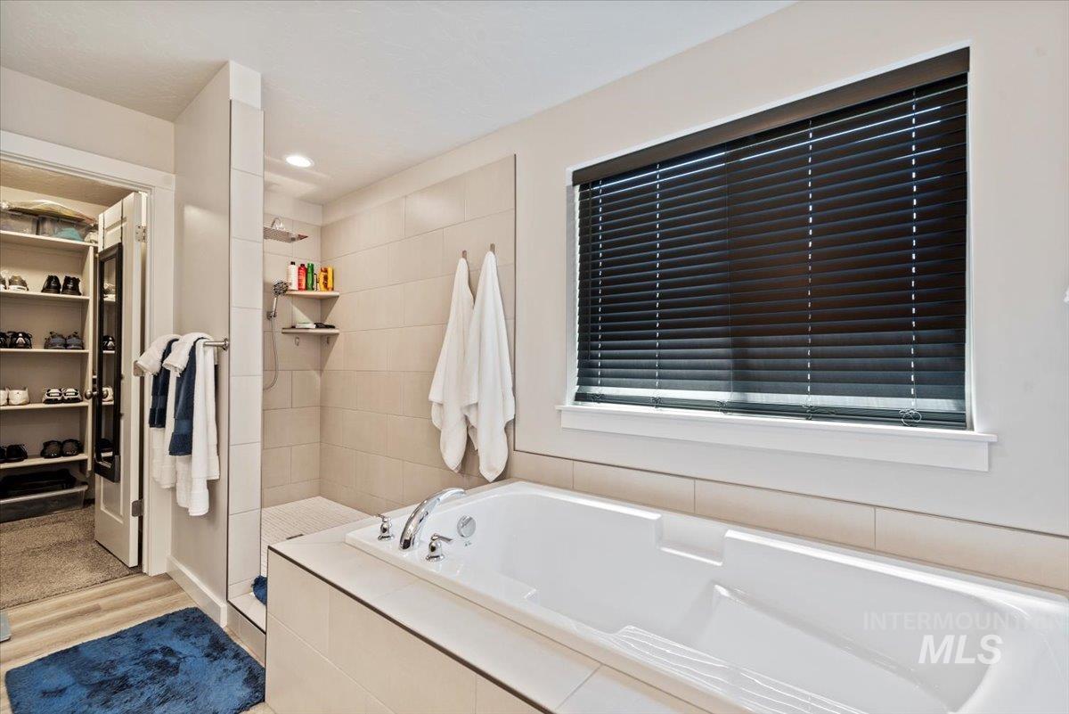 Full bathroom with a garden tub and walk in shower
