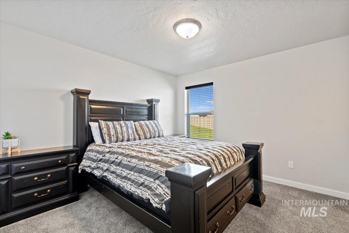 Bedroom with carpet and a textured ceiling