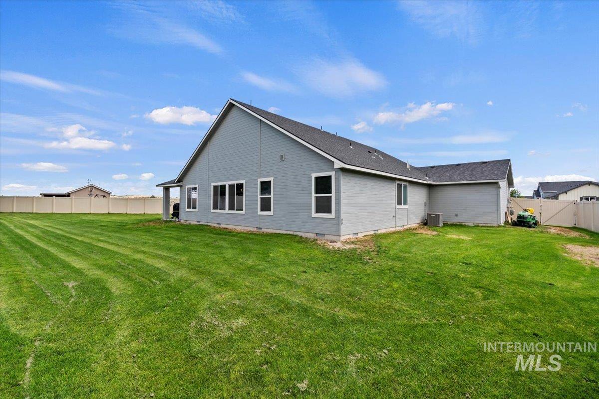 Rear view of house featuring a fenced backyard and crawl space