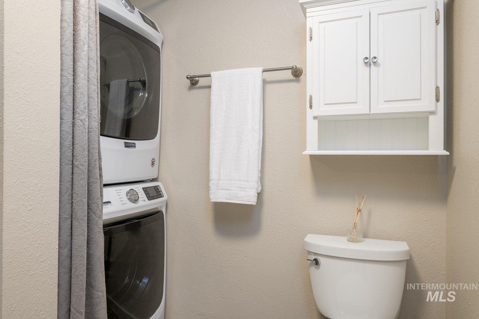 Laundry room featuring estacked washer and dryer