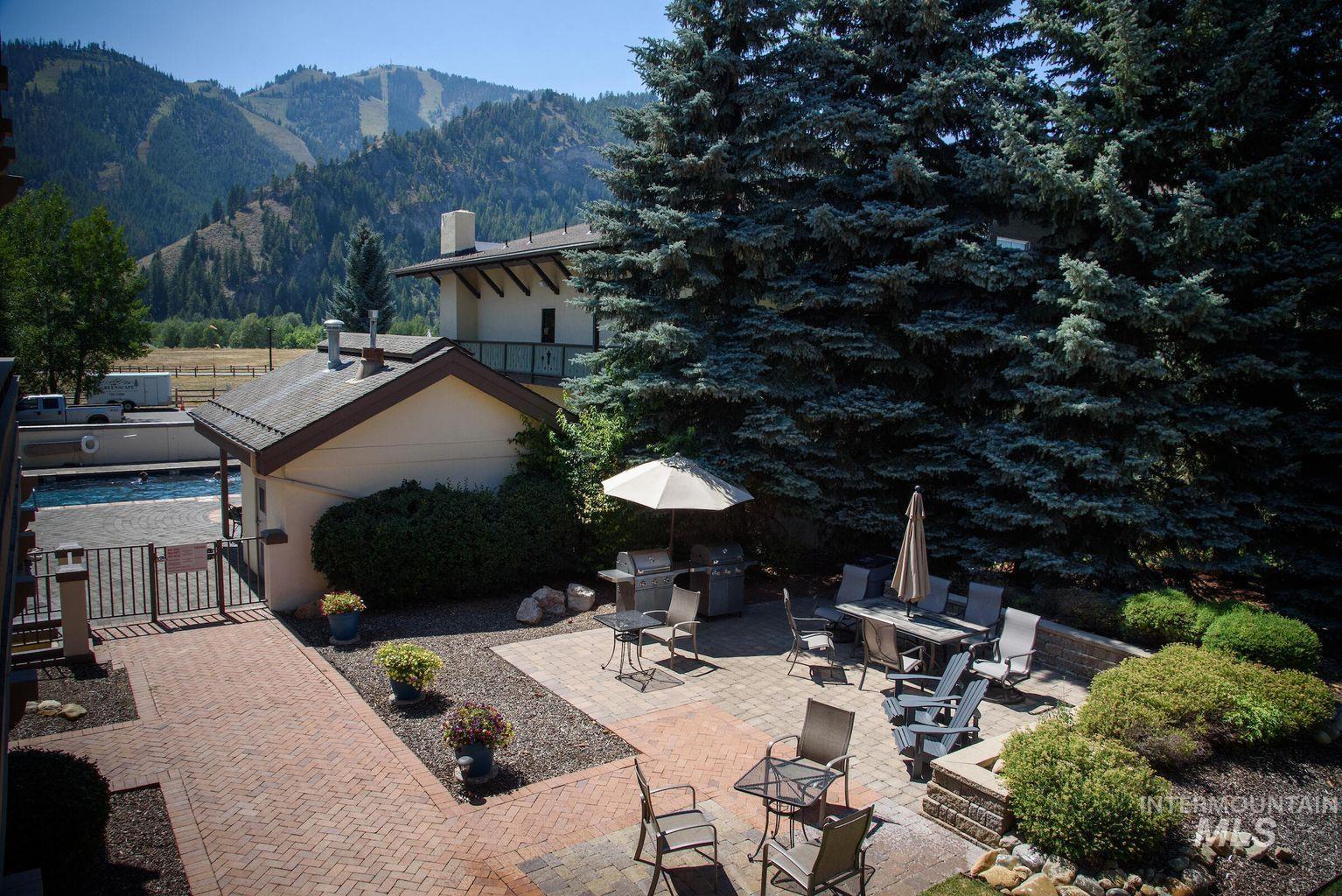 View of patio / terrace with a mountain view, a gate, and area for grilling