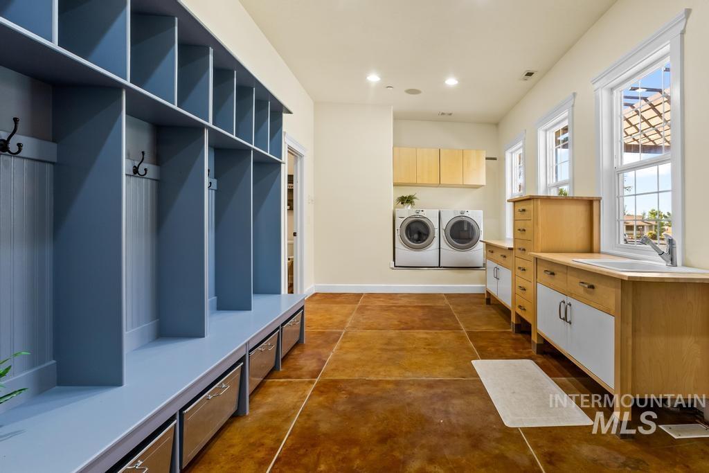 Mudroom with washing machine and dryer and recessed lighting