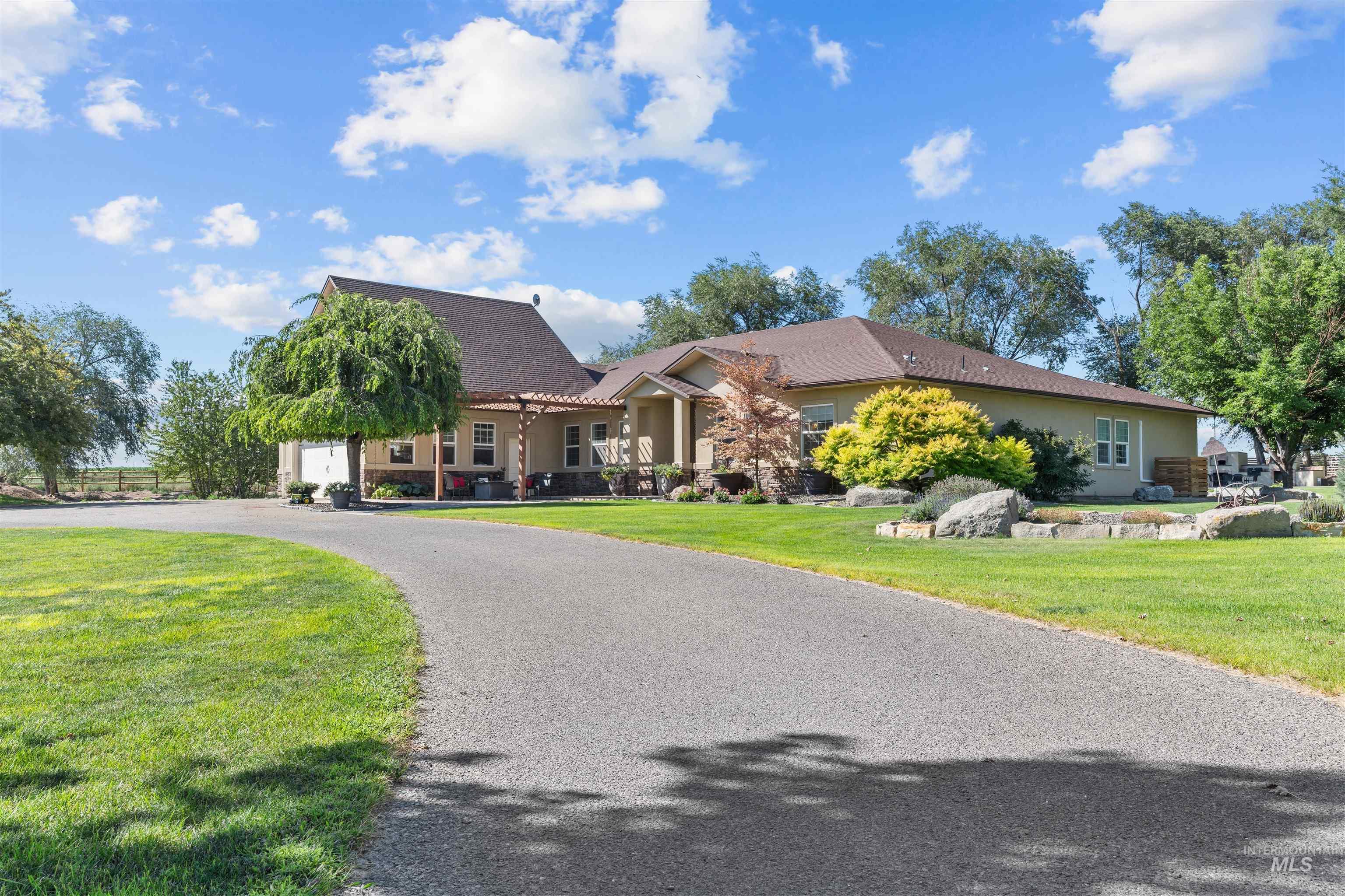 View of front facade with stucco siding, a front lawn, and driveway