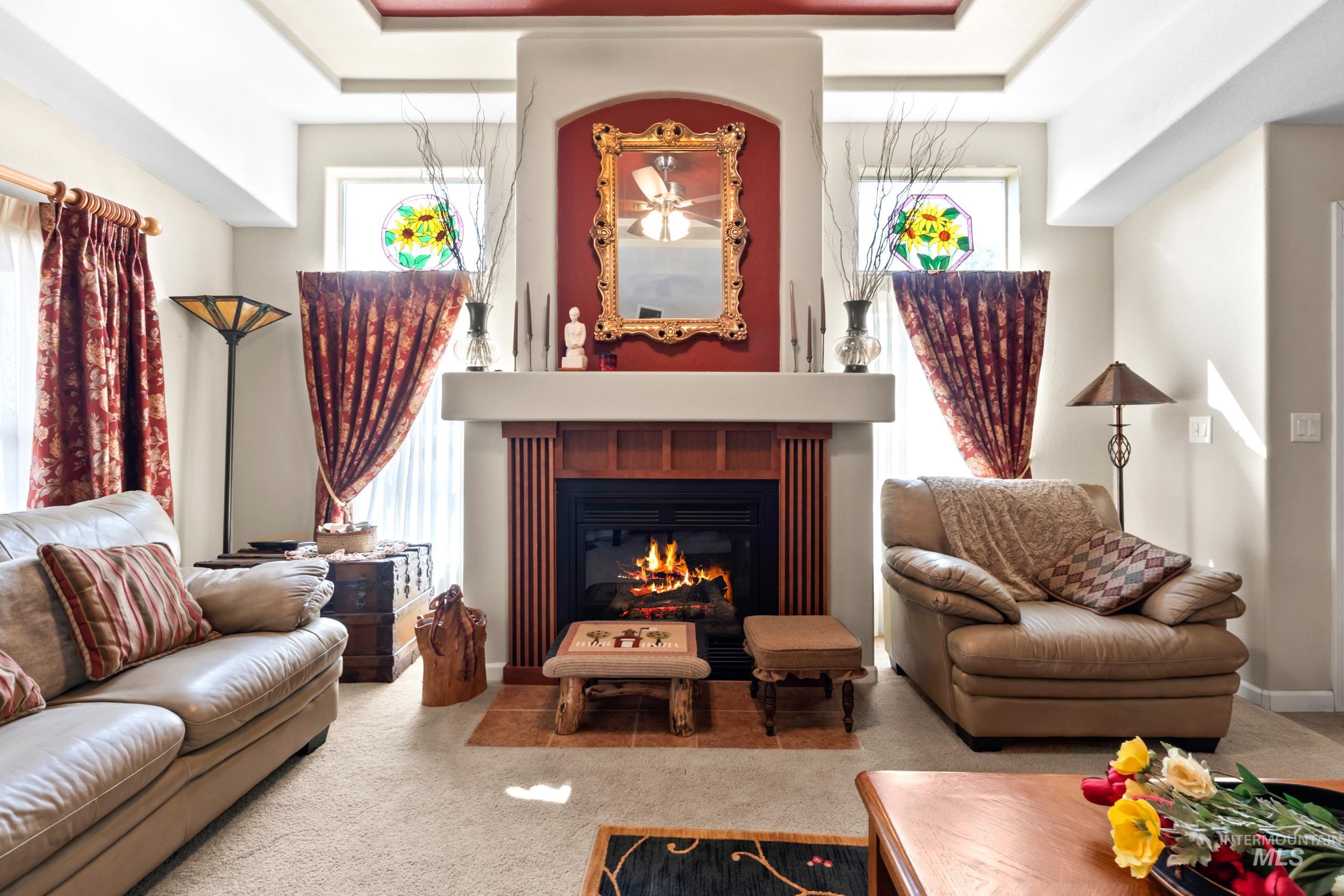 Sitting room featuring carpet floors and a glass covered fireplace