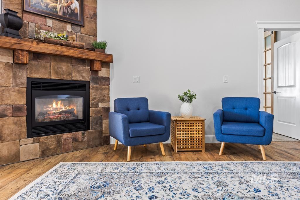 Living area with a glass covered fireplace and wood finished floors
