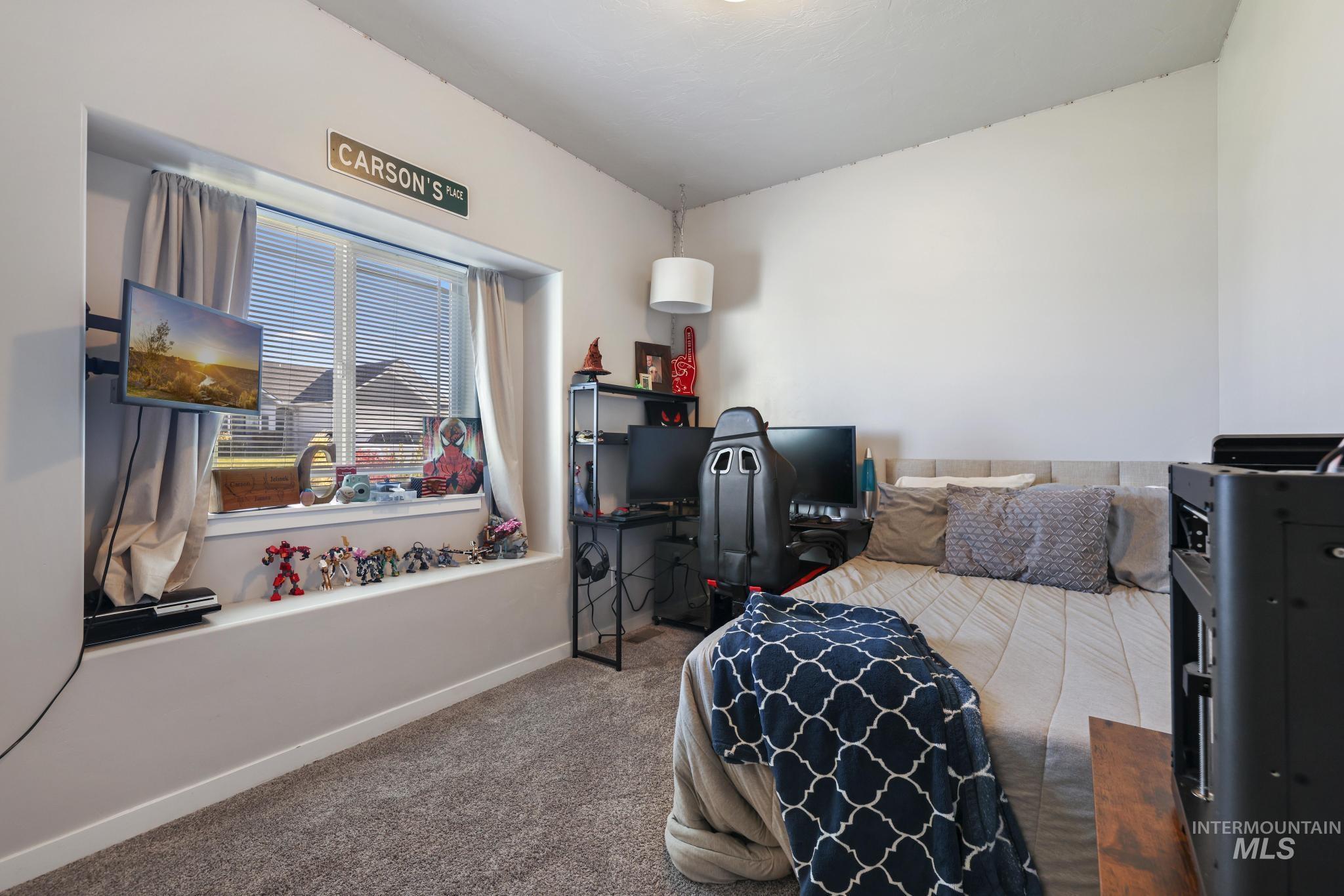 Bedroom featuring carpet floors and a desk