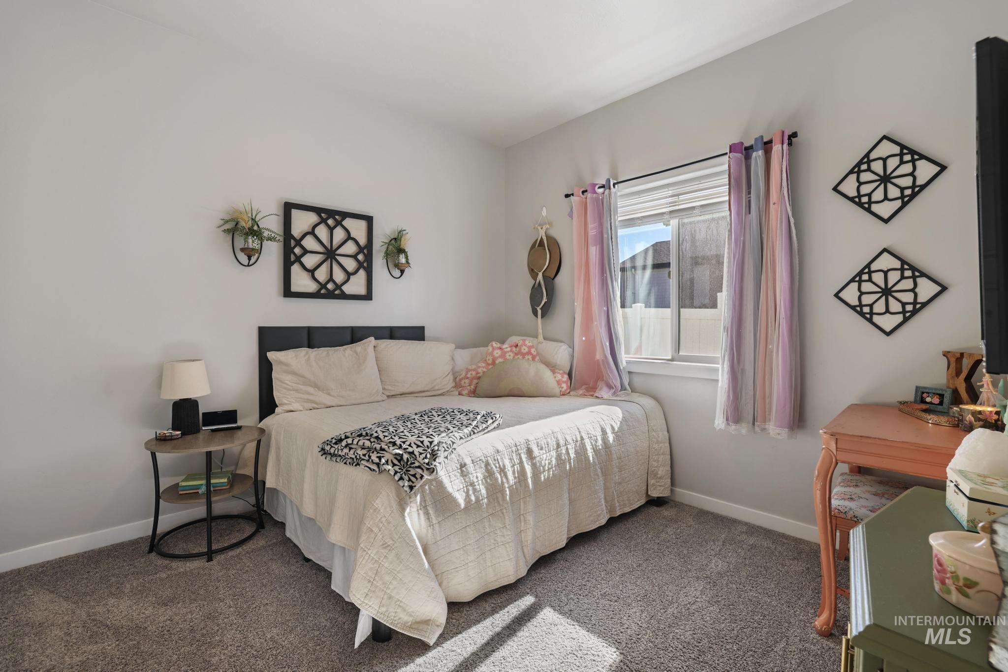 Carpeted bedroom with baseboards