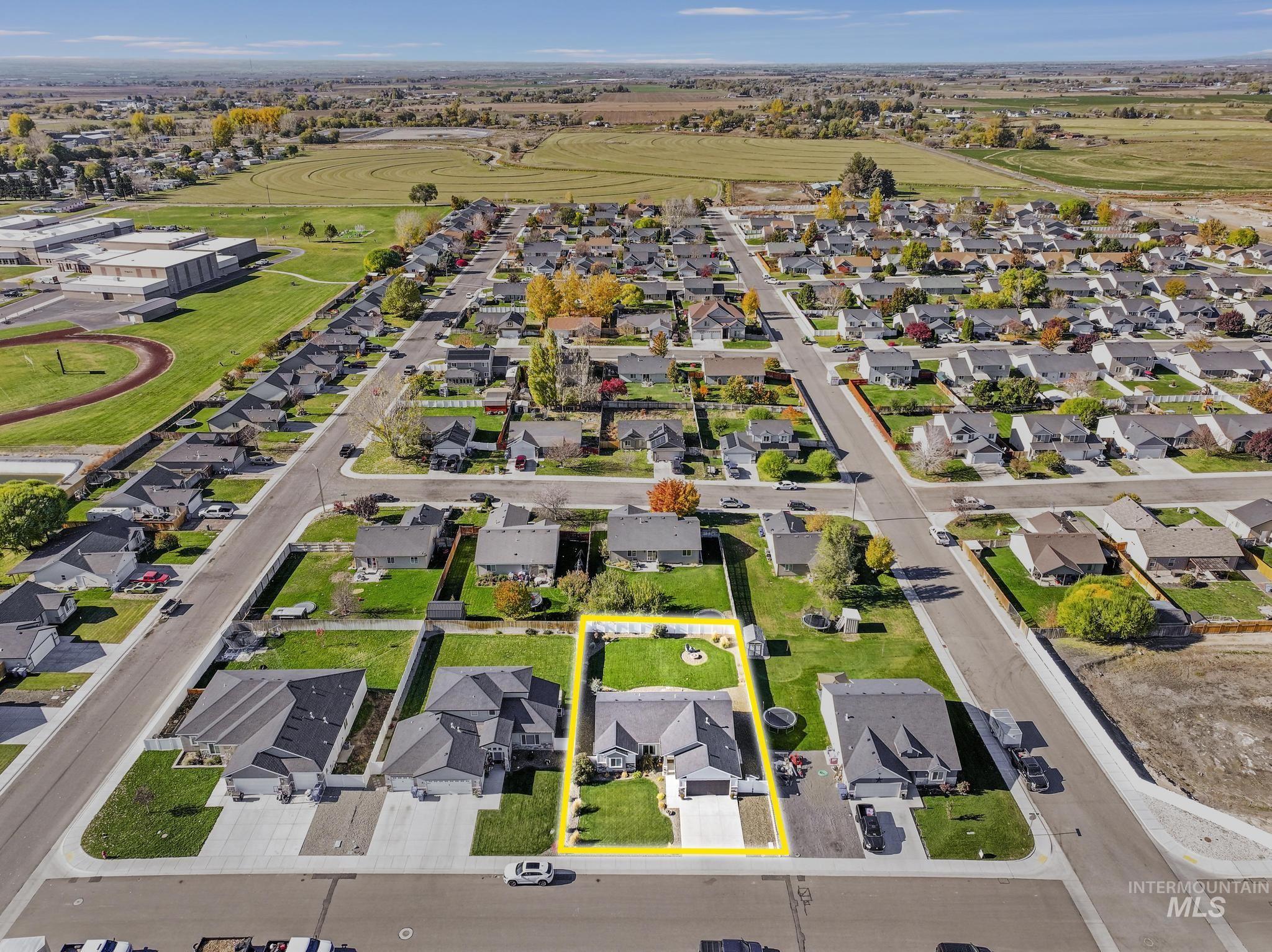Aerial perspective of suburban area featuring property parcel outlined