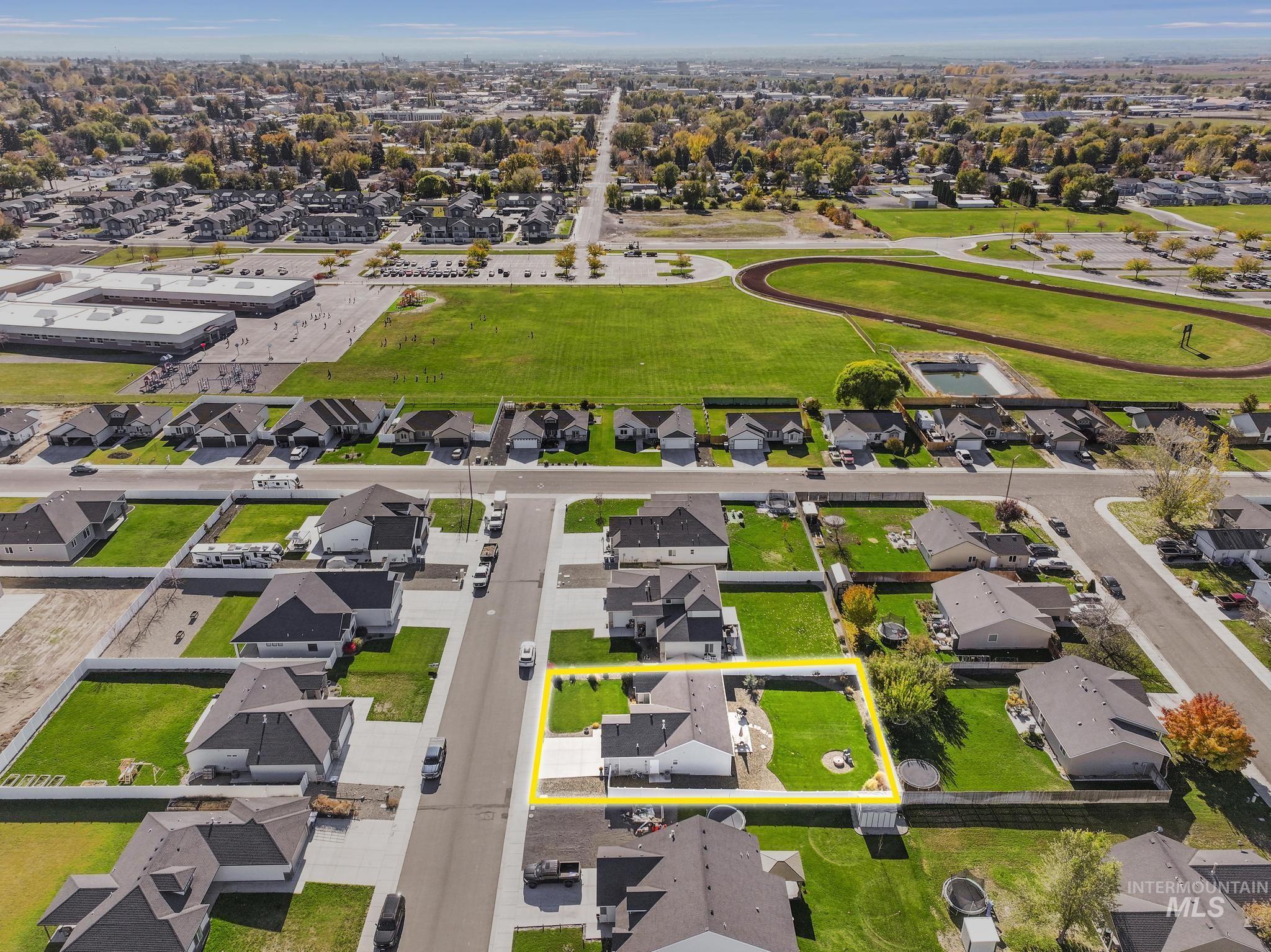 Aerial view of residential area with property parcel outlined