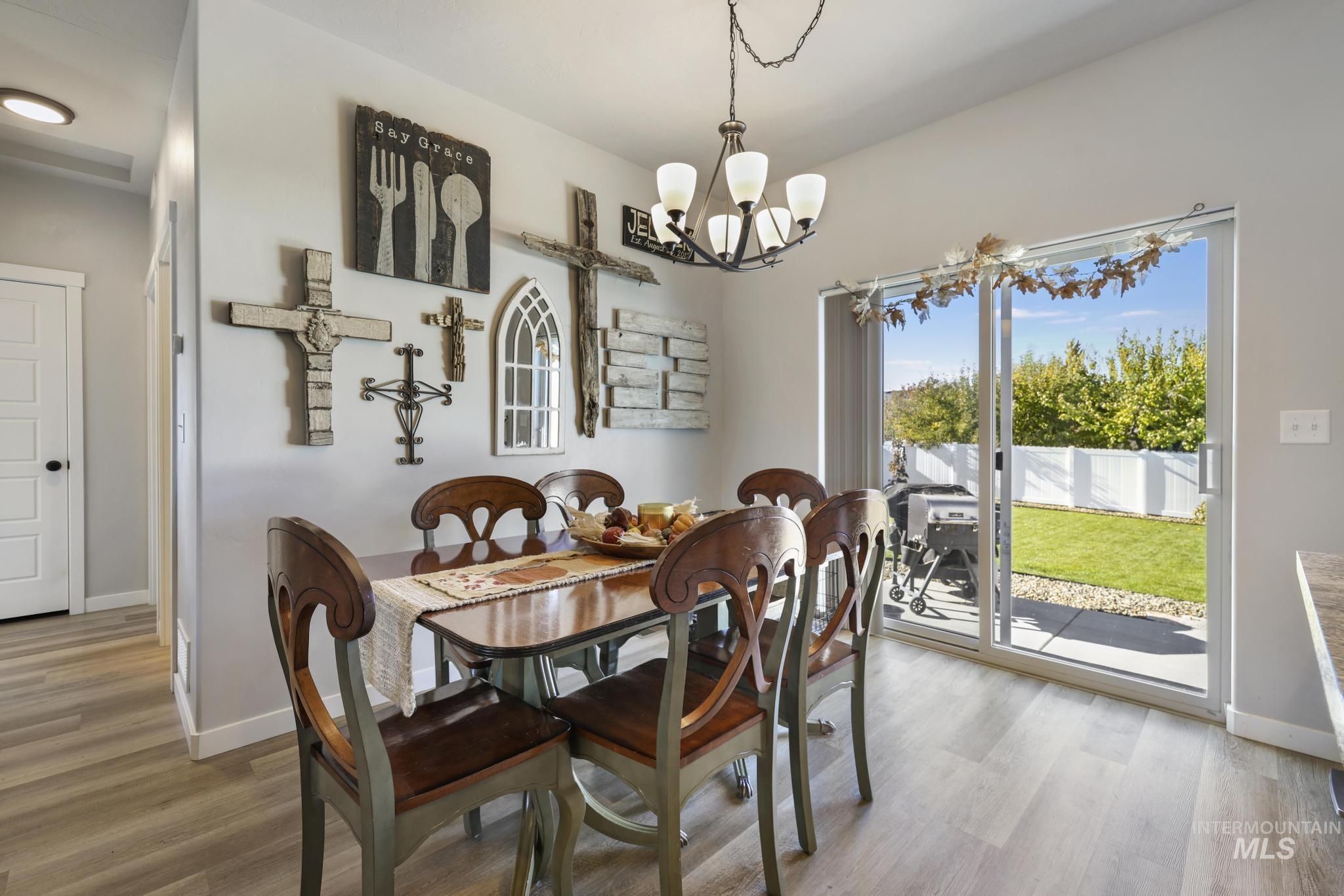 Dining space featuring light wood-style flooring and a chandelier