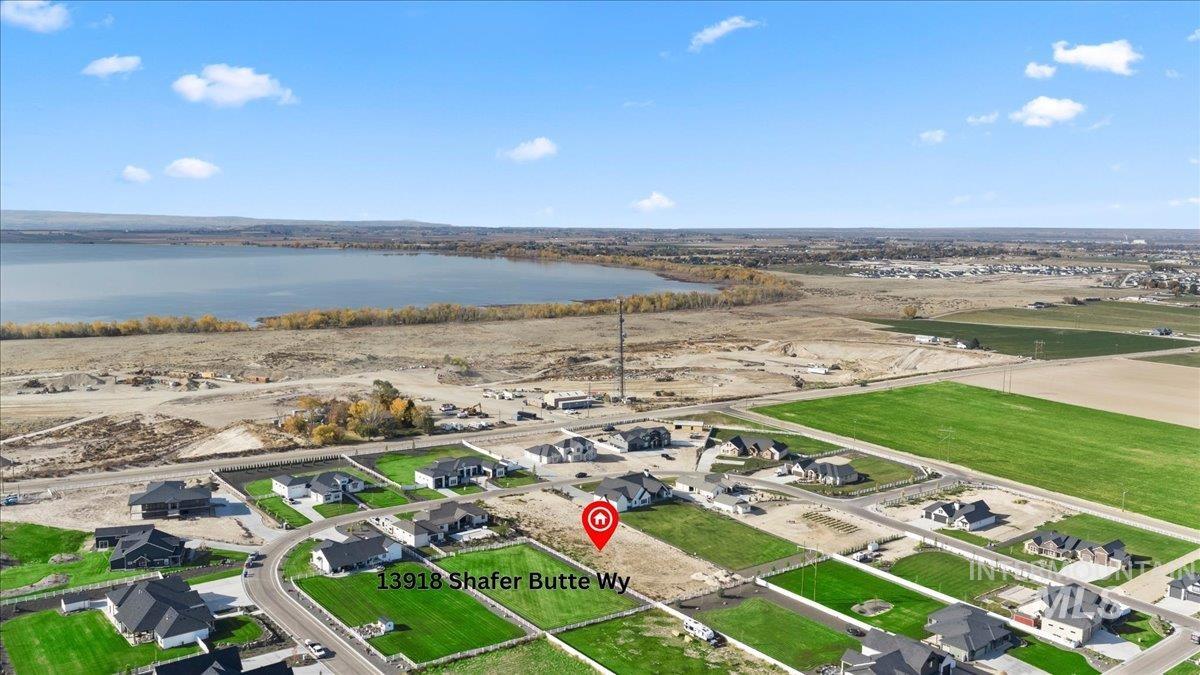 Aerial view of property's location featuring nearby suburban area and a large body of water