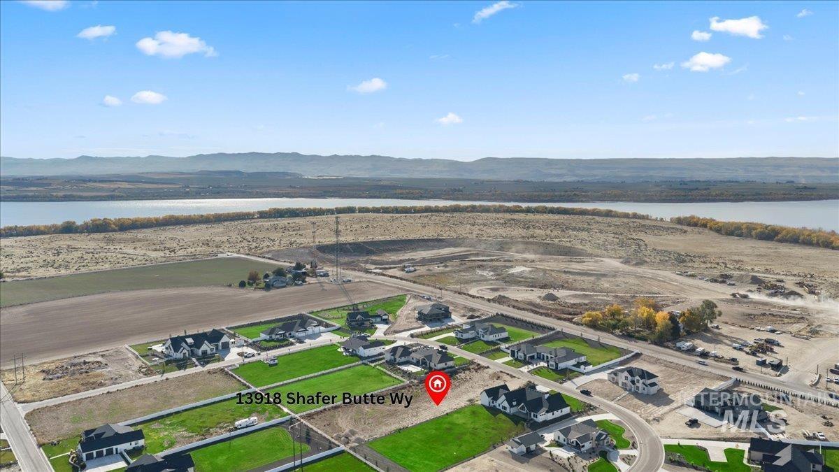 View of property location with a water and mountain view and nearby suburban area