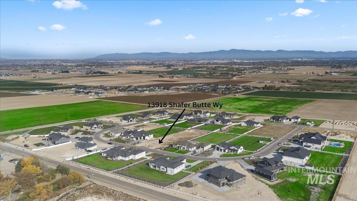 Aerial perspective of suburban area featuring a mountainous background