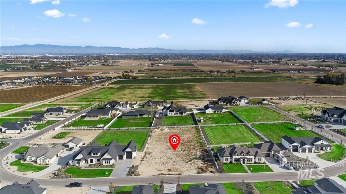 Overview of rural landscape featuring a mountain backdrop and nearby suburban area