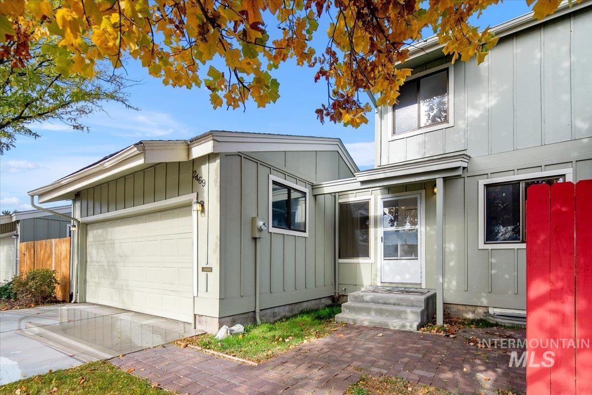View of front facade with board and batten siding, a garage, and concrete driveway