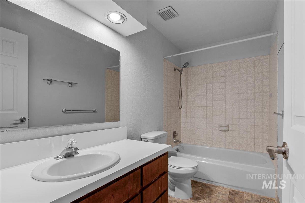 Bathroom with shower / washtub combination and vanity