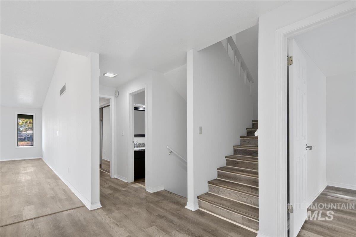 Staircase featuring wood finished floors