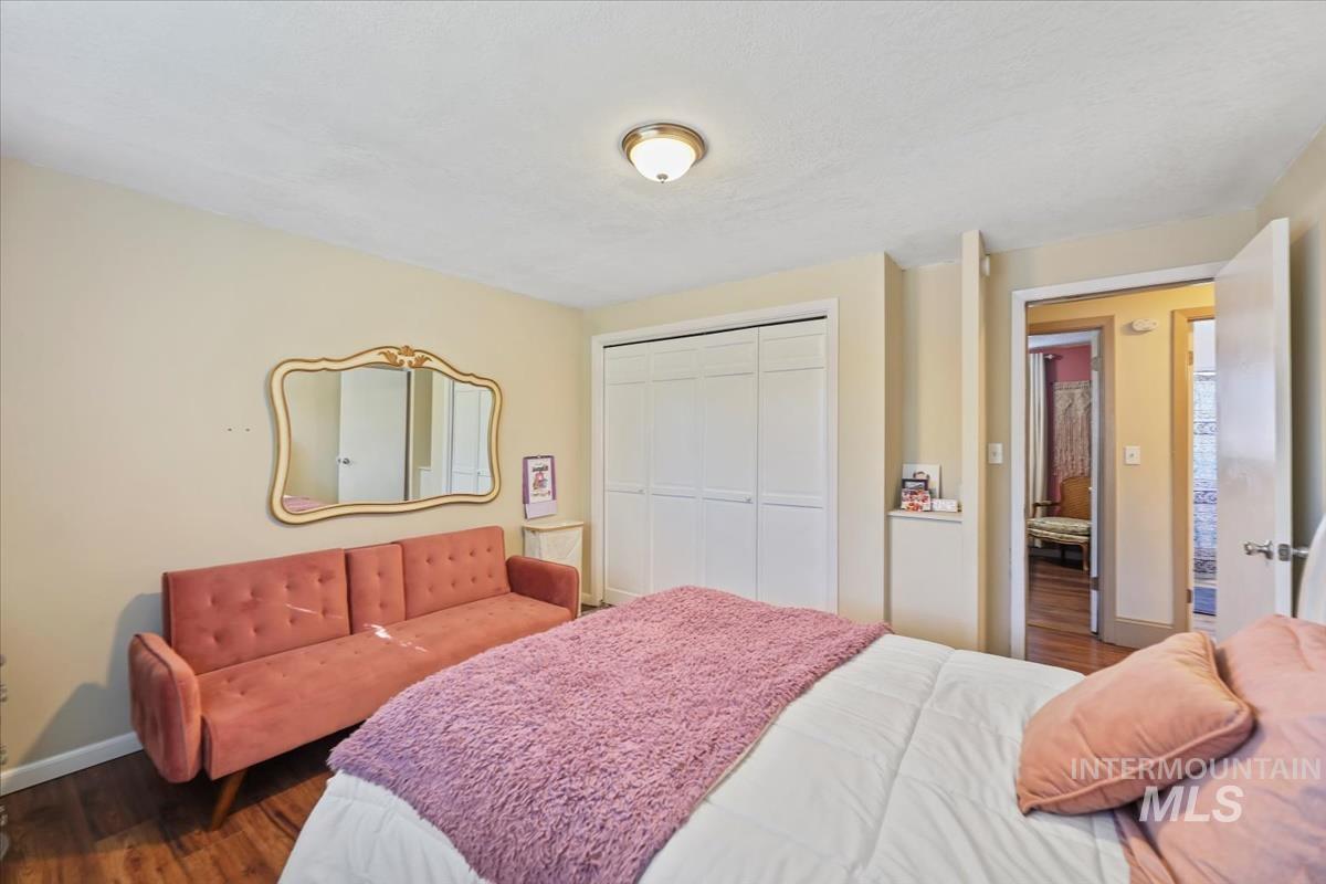 Bedroom featuring wood finished floors and a closet