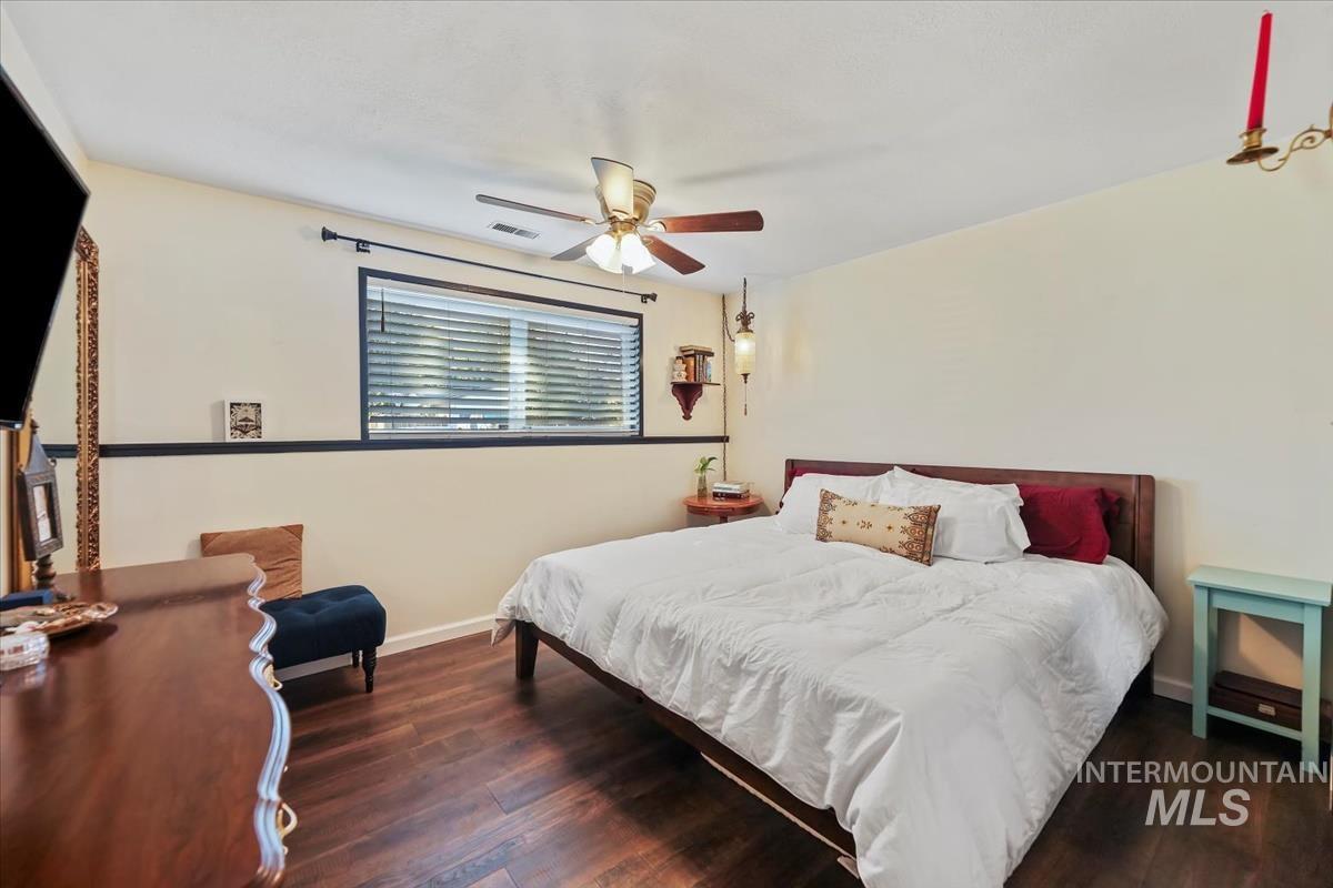 Bedroom featuring dark wood finished floors and a ceiling fan