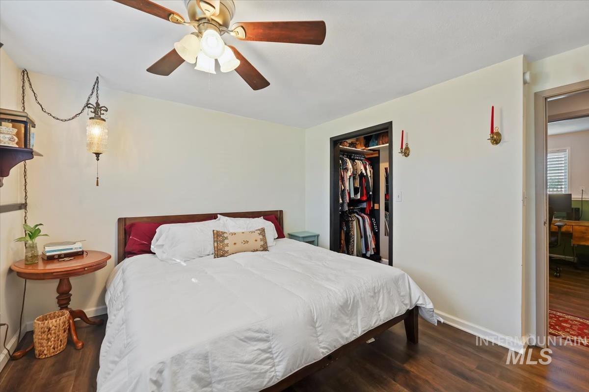 Bedroom with dark wood-style floors and ceiling fan