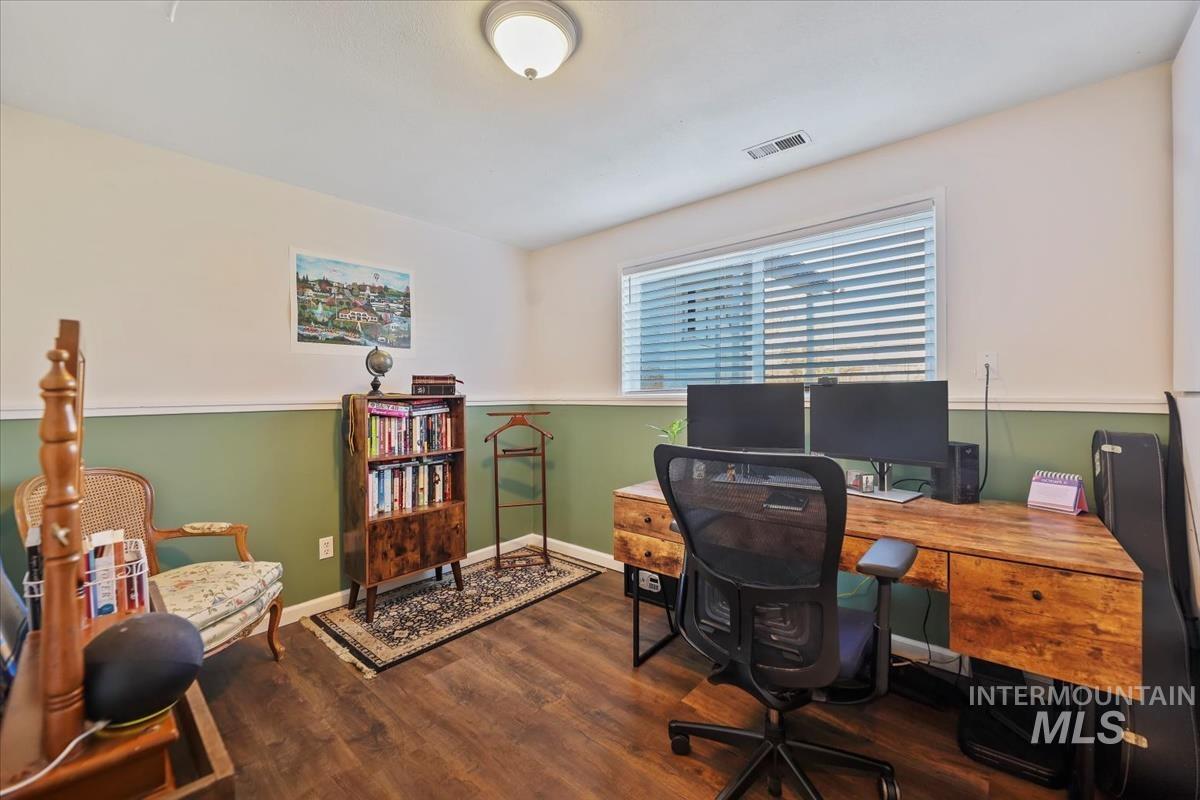Office featuring dark wood-type flooring and baseboards