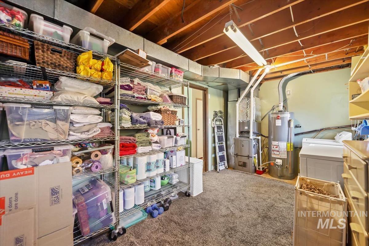 Storage area with water heater, washing machine and clothes dryer, and heating unit