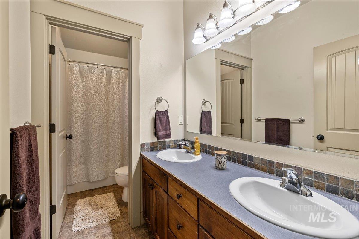 Bathroom featuring double vanity and toilet