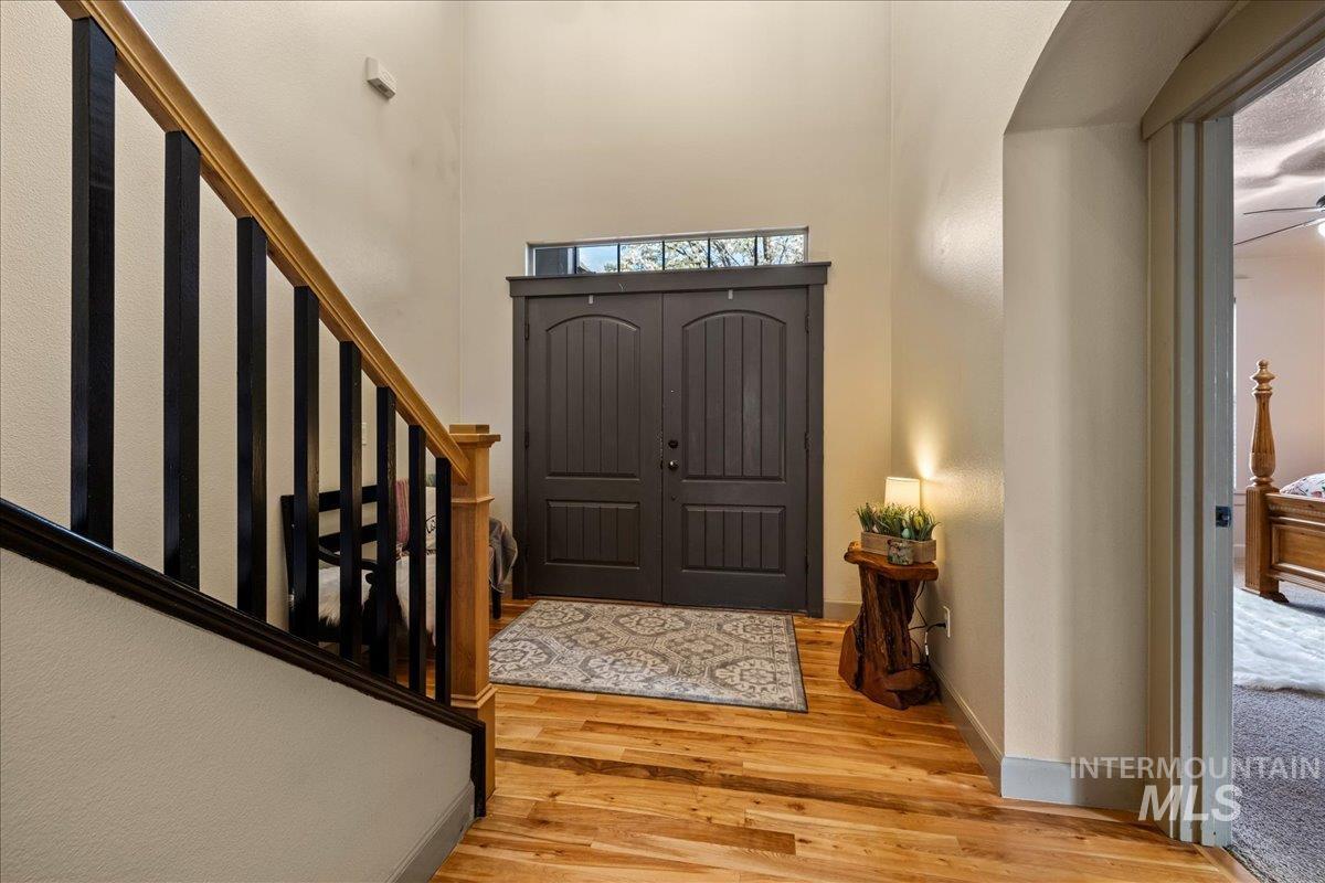 Entryway with light wood-style flooring and stairway