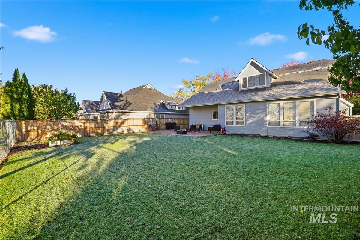 Rear view of property with a patio area and a fenced backyard