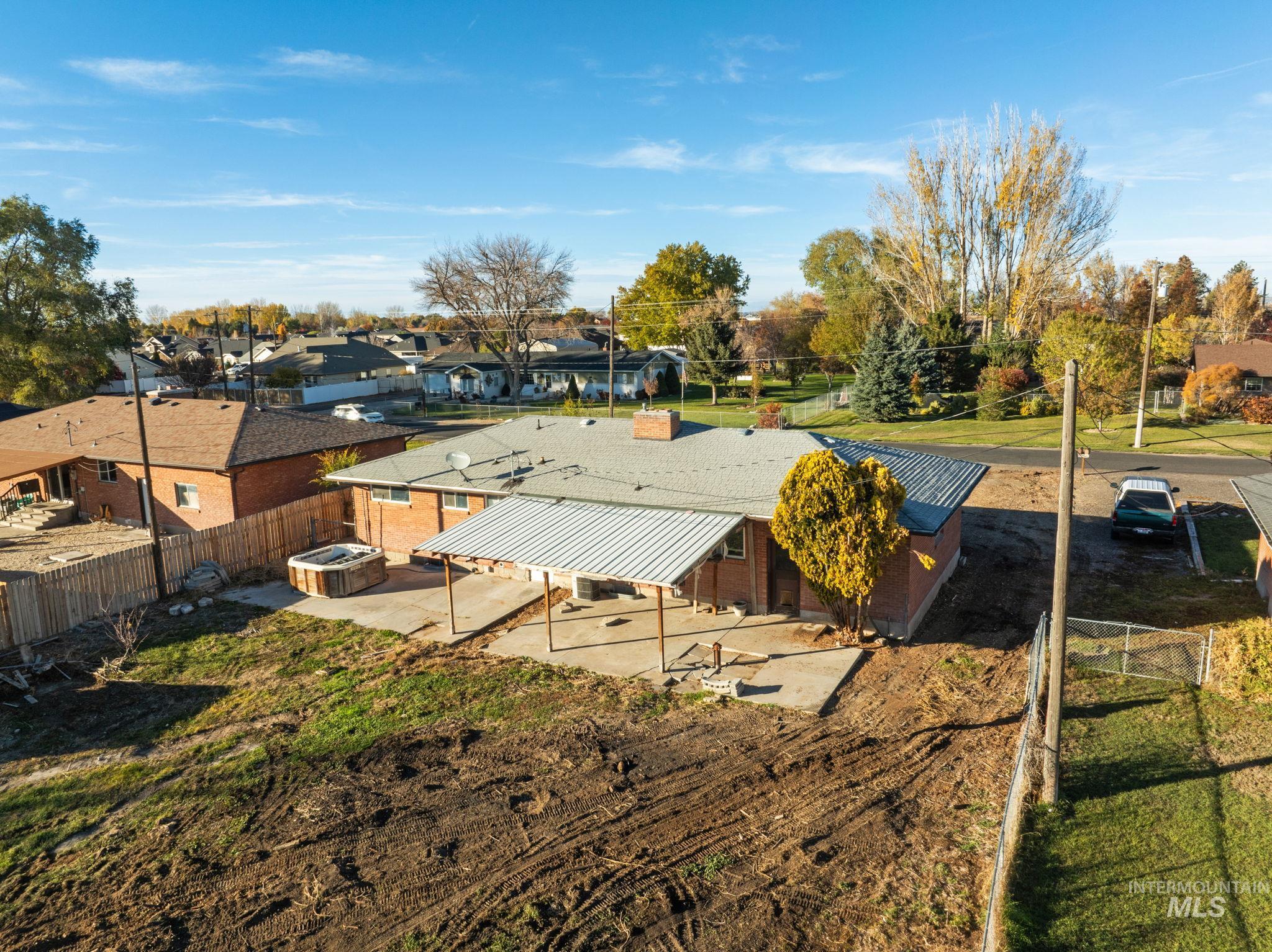 Fenced backyard with a residential view and a patio