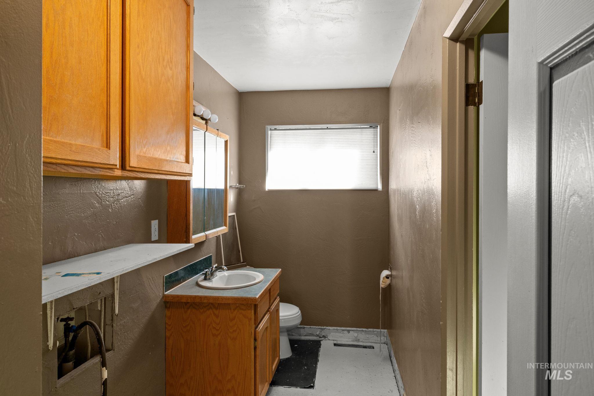 Half bathroom with vanity and toilet