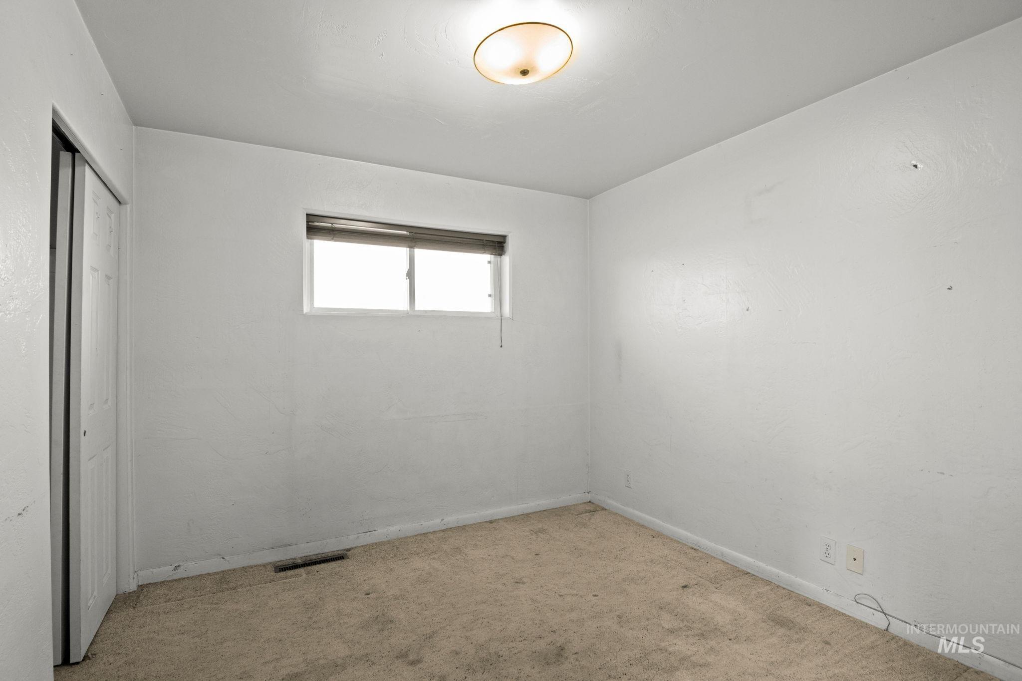 Unfurnished bedroom featuring carpet flooring and a closet