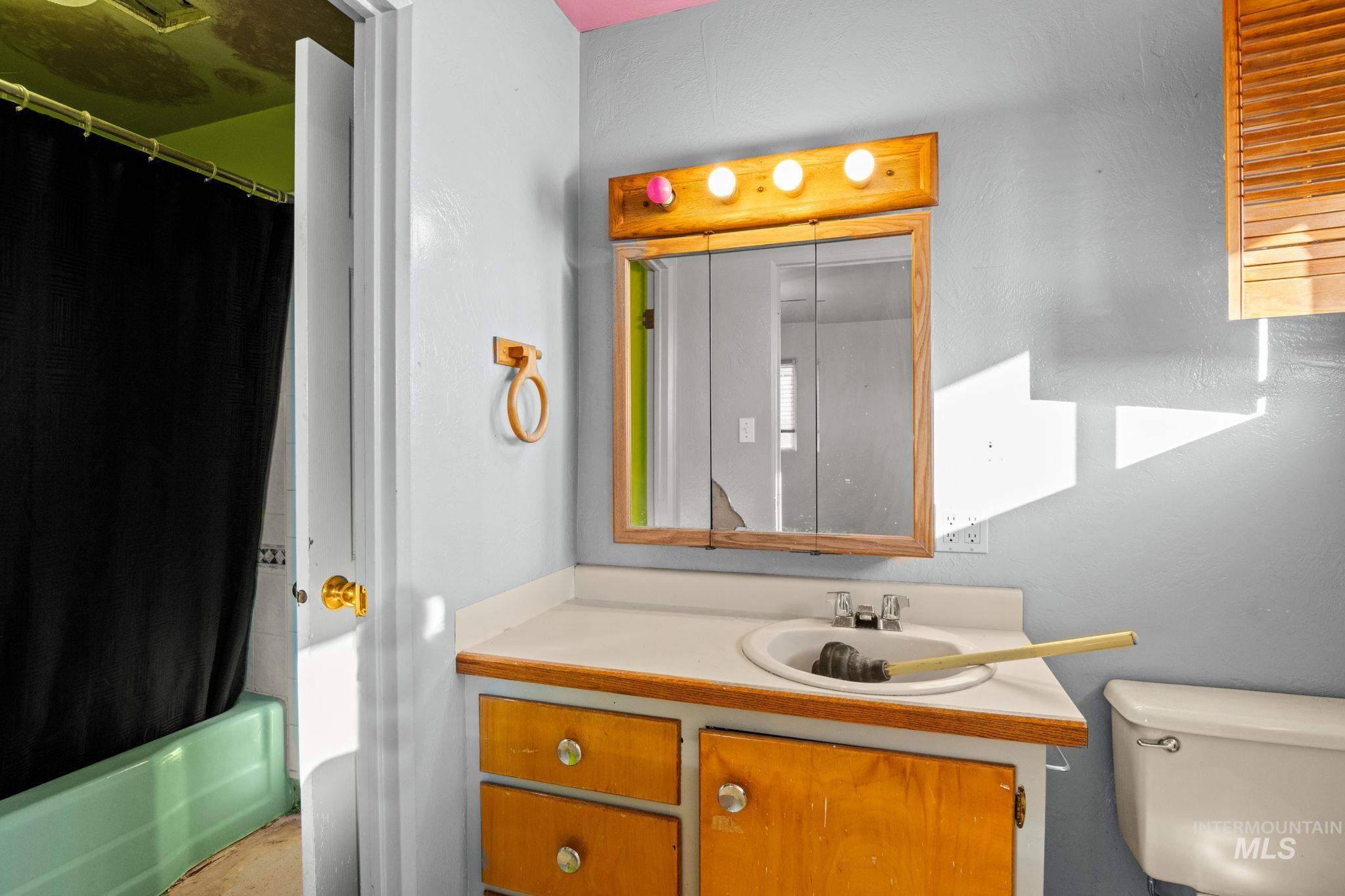 Full bathroom with vanity and shower / bath combo with shower curtain