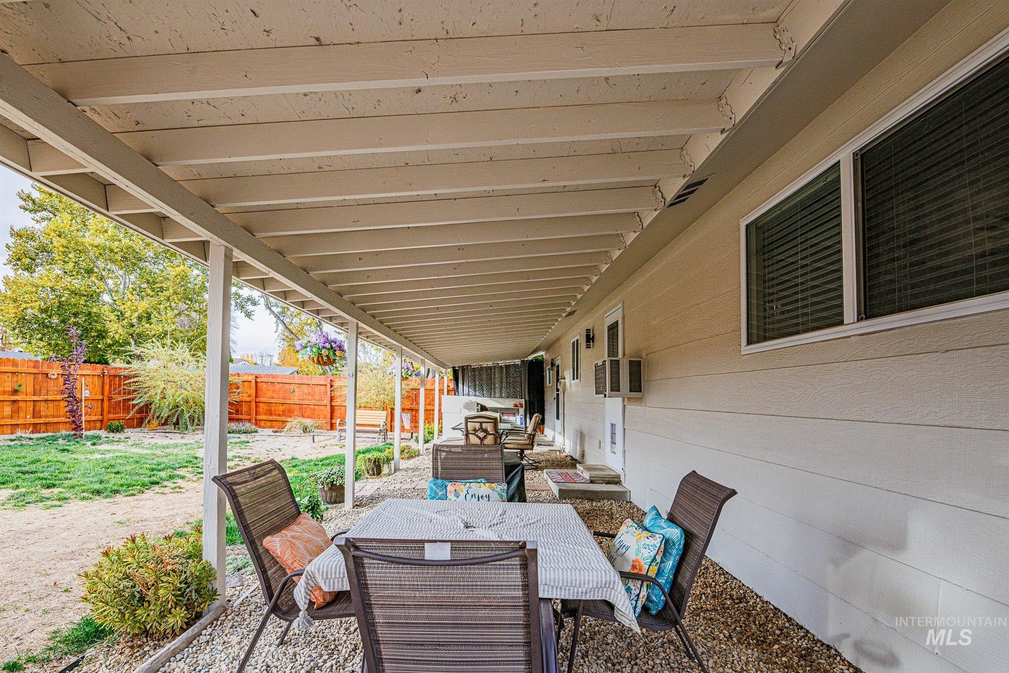 Fenced backyard with a patio and outdoor dining area