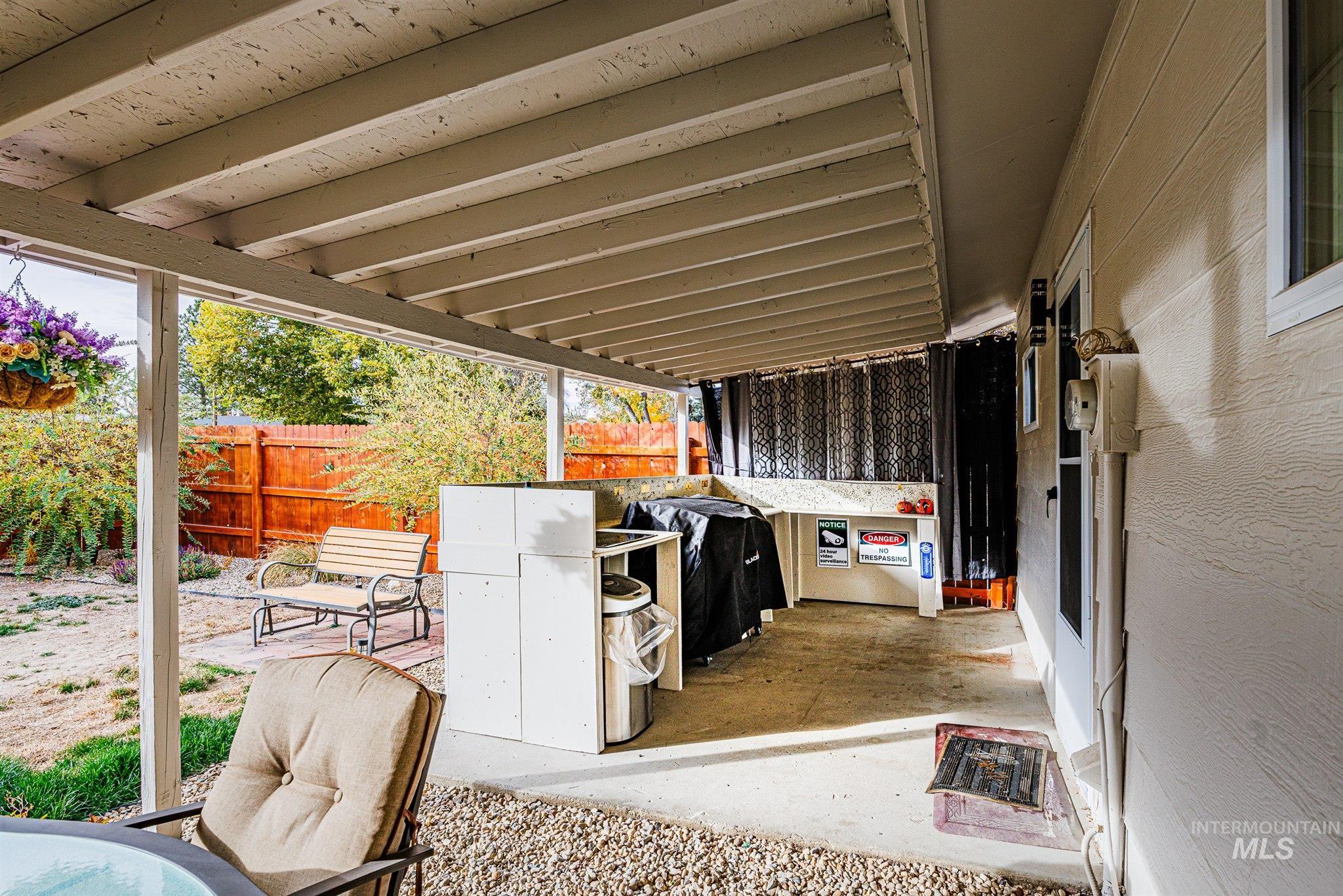 View of patio with a grill