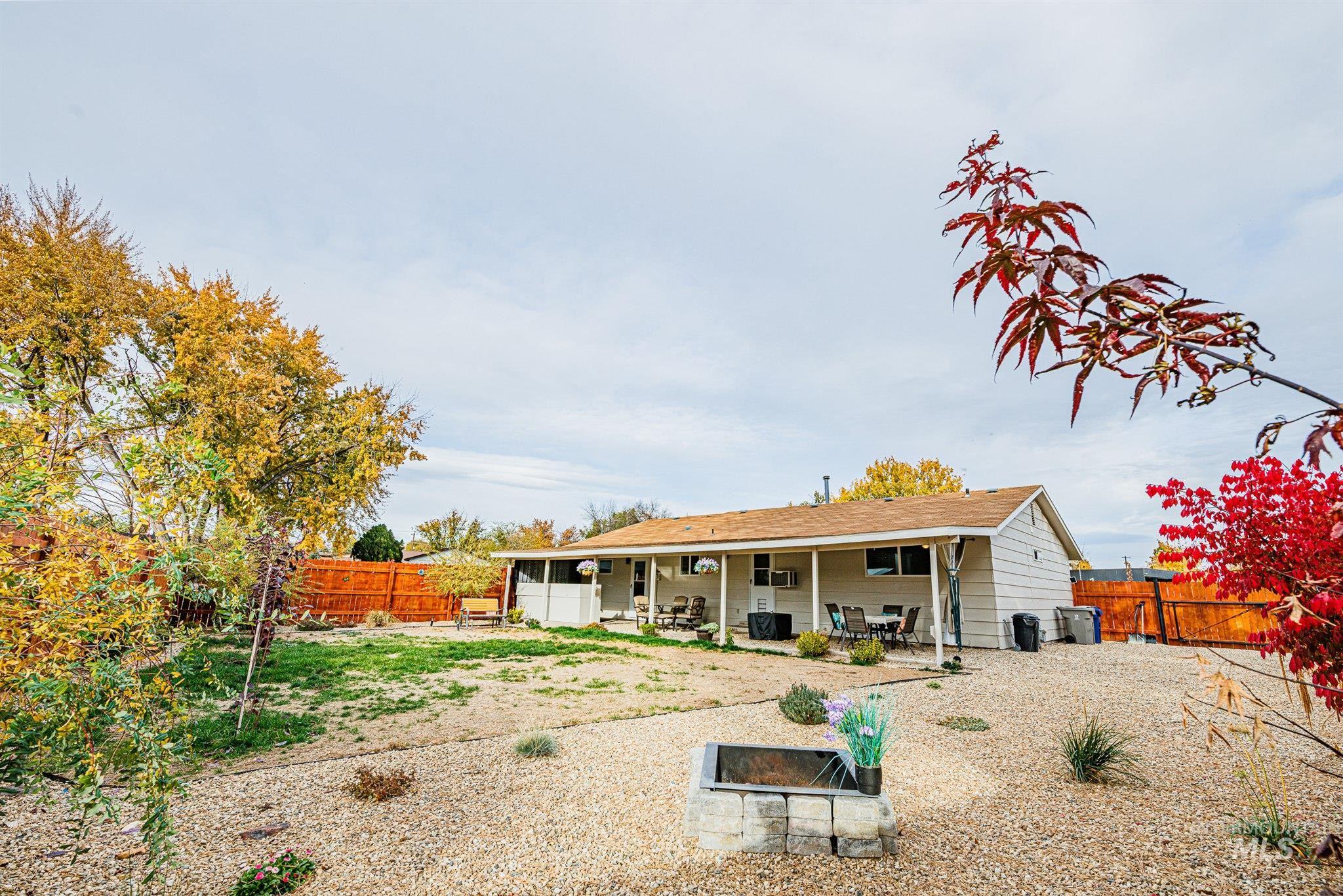 Rear view of house with a patio area and a fenced backyard