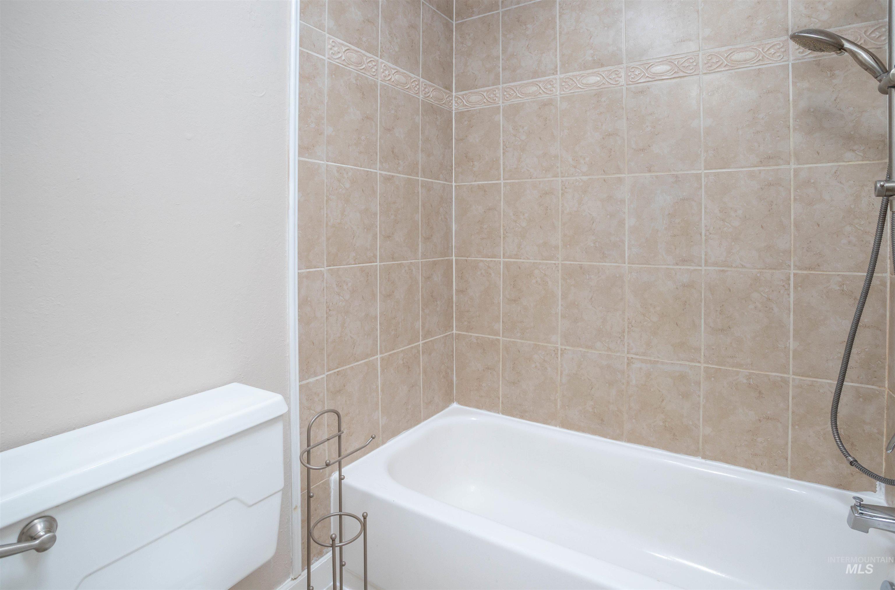Bathroom with washtub / shower combination and toilet