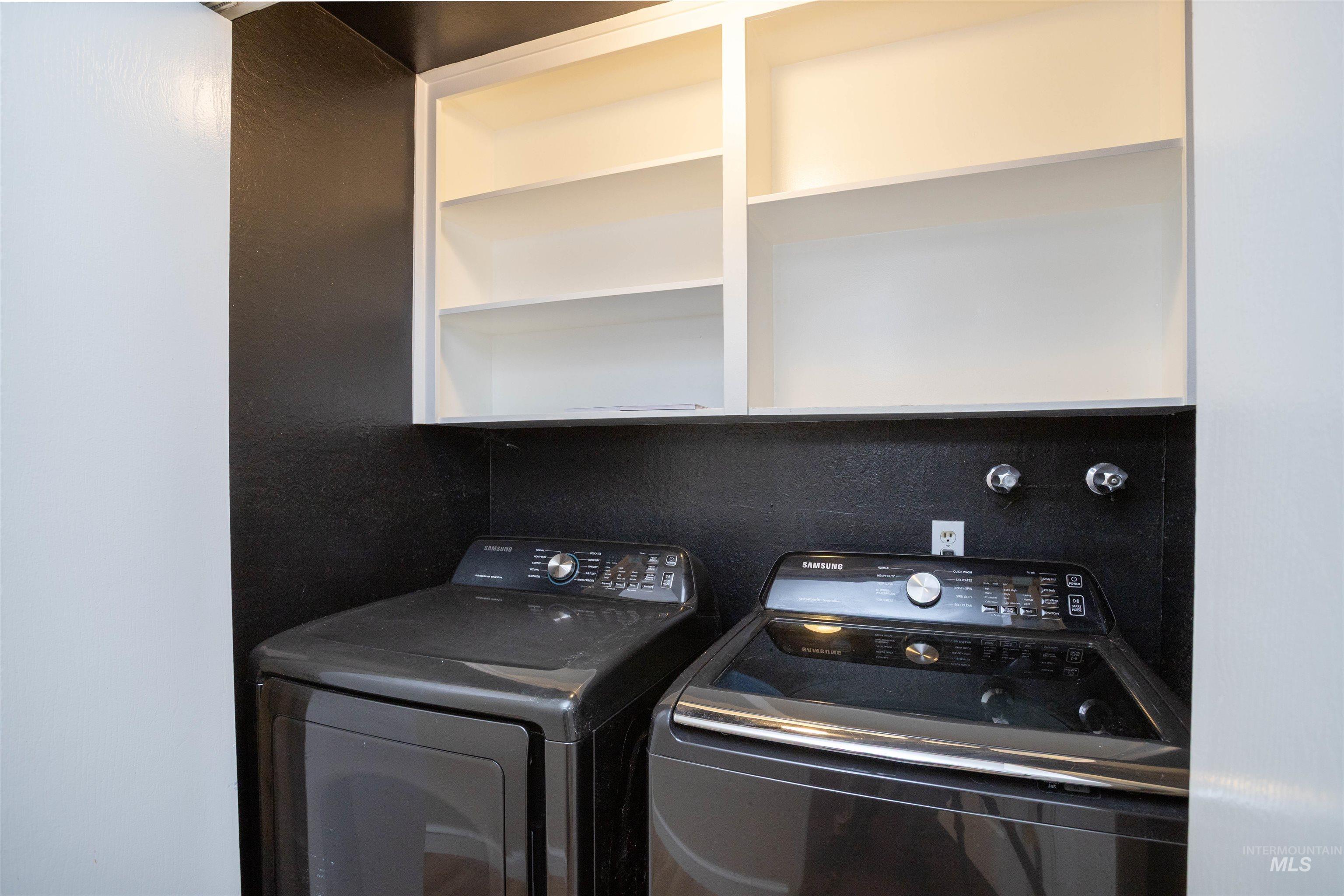Washroom featuring washing machine and dryer