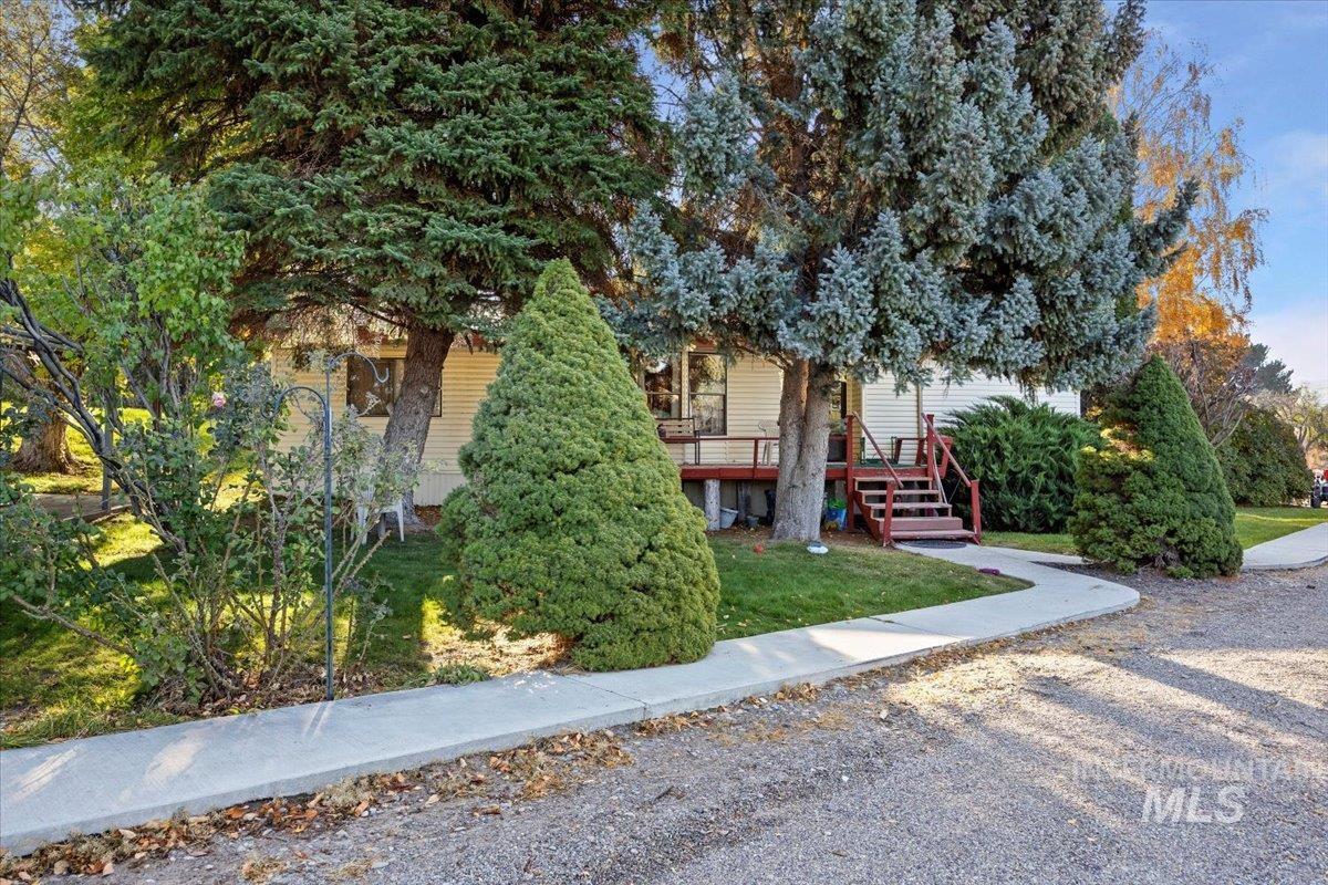View of front of property featuring a front lawn and a deck