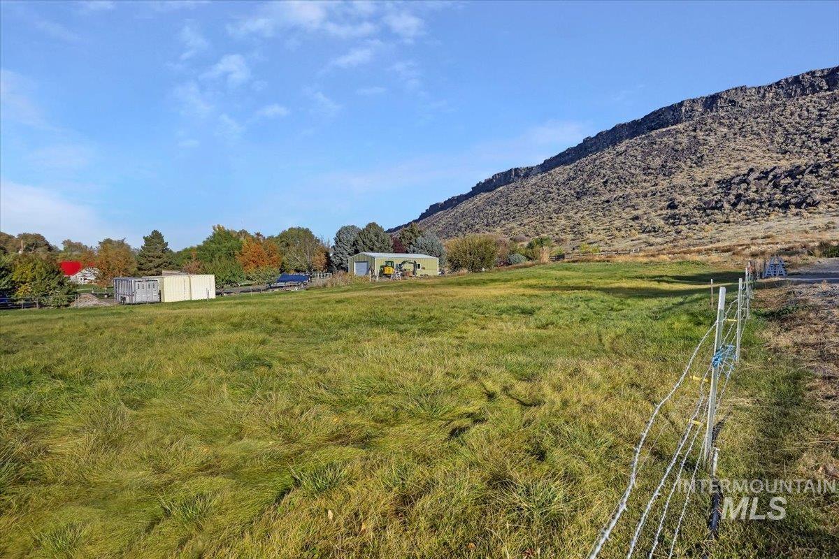 View of yard featuring a view of rural / pastoral area and a mountain view