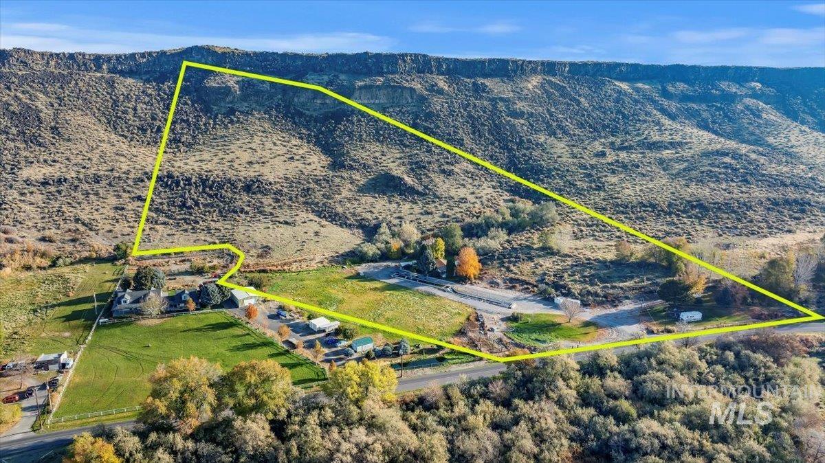 Overview of rural landscape with property parcel outlined and mountains