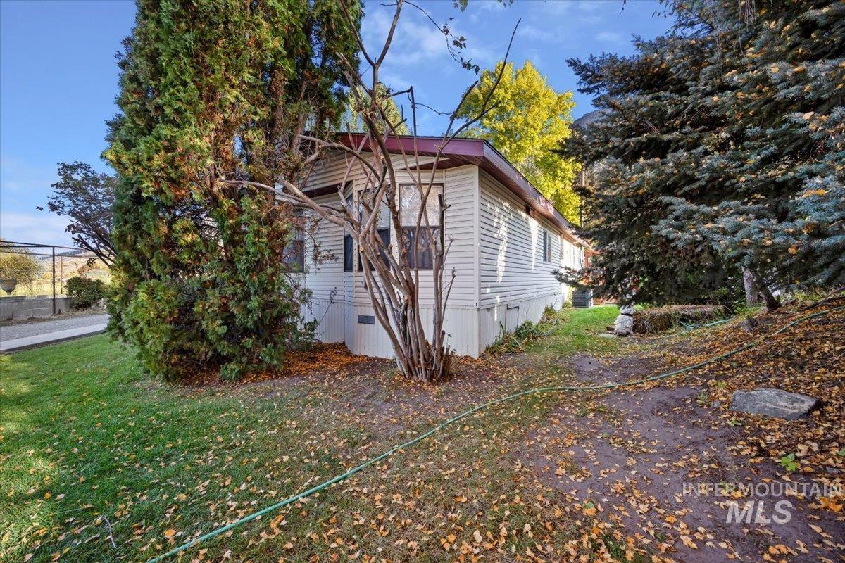 View of side of home with a yard