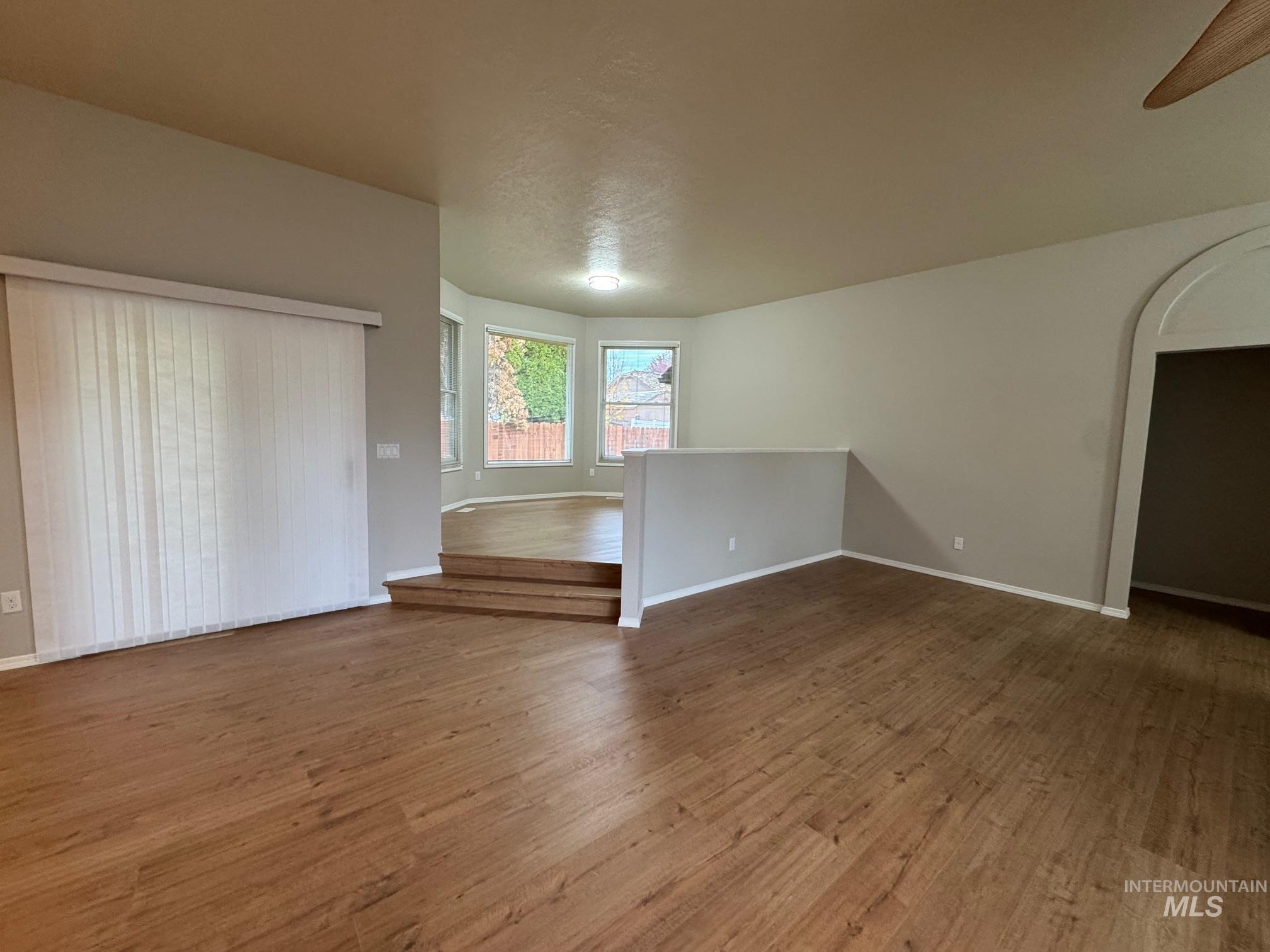 Unfurnished room featuring wood finished floors and baseboards