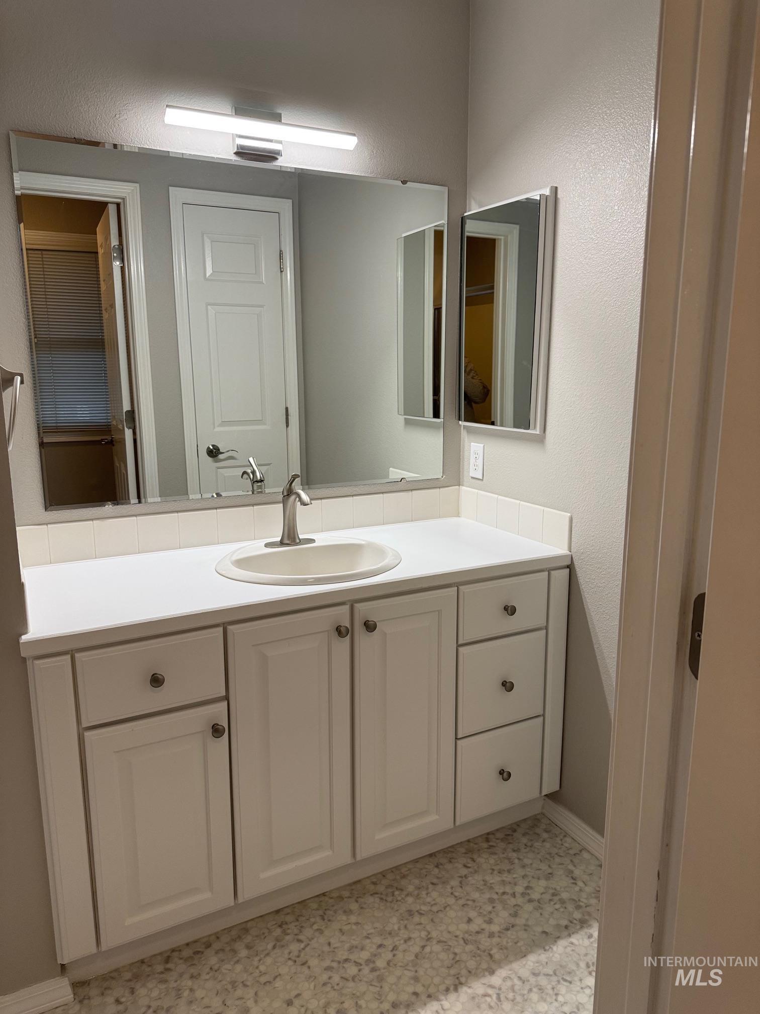 Bathroom with vanity and baseboards