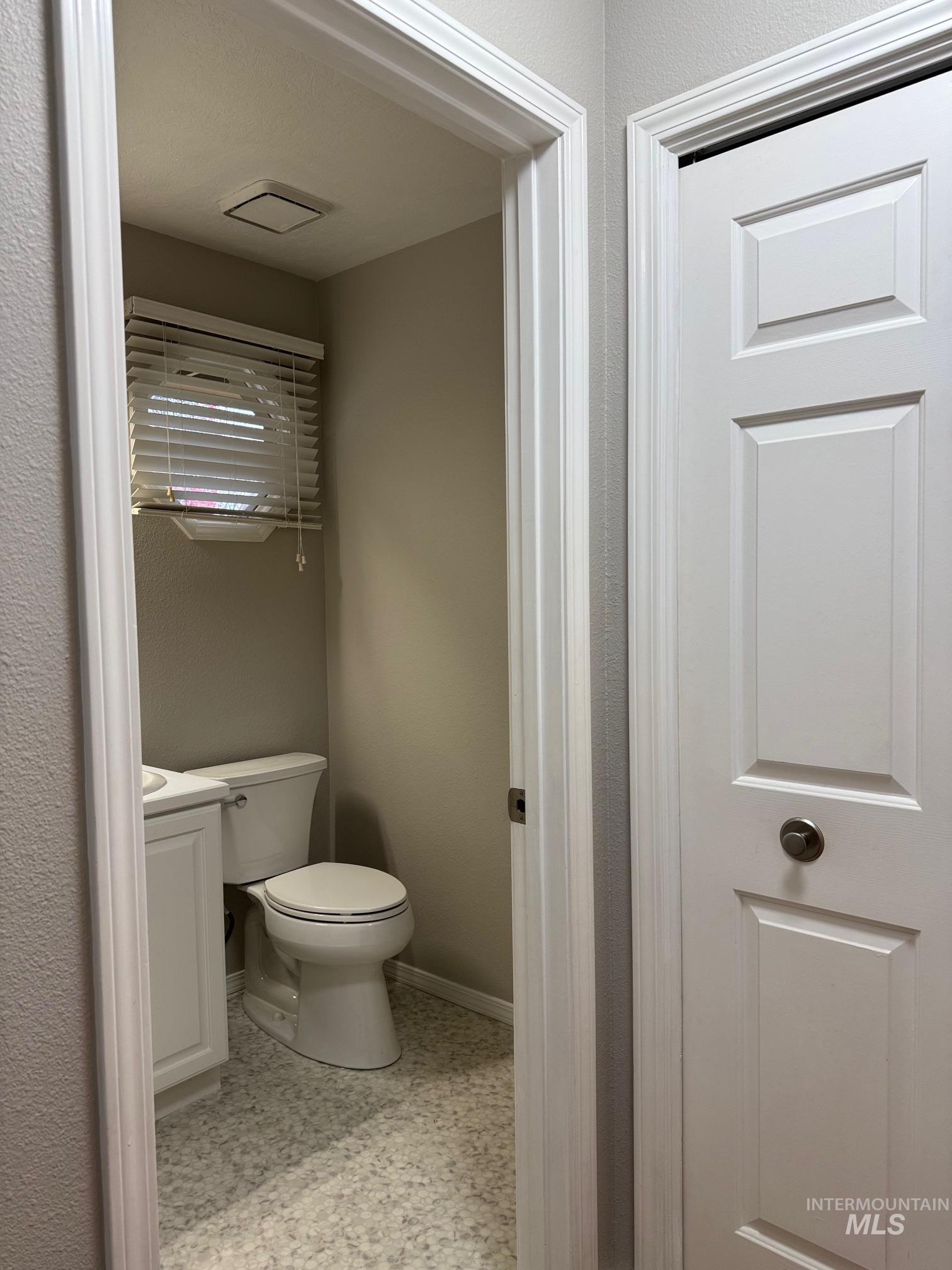 Half bath featuring vanity and toilet